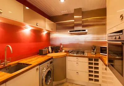 a kitchen with a sink and a washing machine at The Coates Gardens Residence in Edinburgh