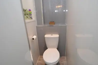 a bathroom with a white toilet and a sink at Sebright Holiday Apartment in Dunoon