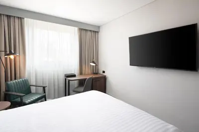 a hotel room with a bed and a flat screen tv at Four Points by Sheraton Edinburgh in Edinburgh