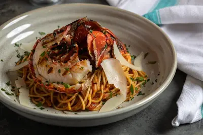 a plate of food with shrimp on pasta at Four Points by Sheraton Edinburgh in Edinburgh