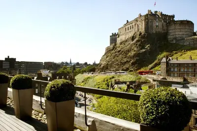 a view of a castle from the balcony of a building at Apex Grassmarket Hotel in Edinburgh