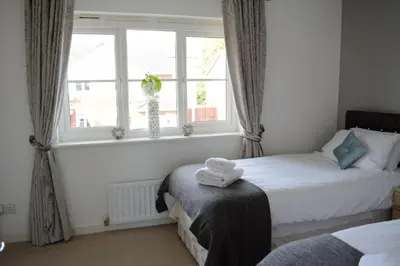 a bedroom with two beds and a window at Glasgow Hampden House in Glasgow
