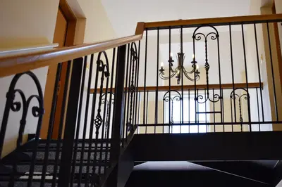 a staircase with a wrought iron railing and a stair case at Benoch Lomond Castle in Alexandria