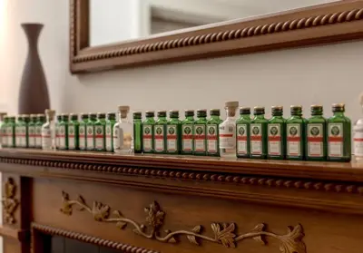a row of green bottles sitting on top of a shelf at The Lothian Road Residence in Edinburgh