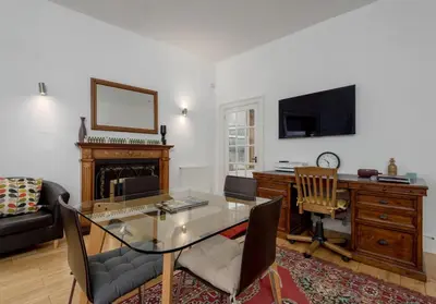 a living room with a glass table and a television at The Lothian Road Residence in Edinburgh