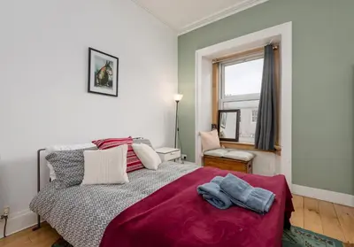 a bedroom with a bed and a window at The Lothian Road Residence in Edinburgh