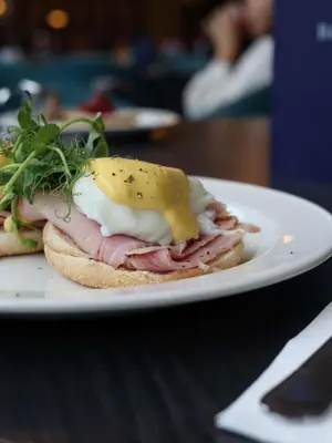 a sandwich with meat and cheese on a plate at Doubletree by Hilton Edinburgh City Centre in Edinburgh