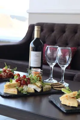 a table with a bottle of wine and two wine glasses at Doubletree by Hilton Edinburgh City Centre in Edinburgh