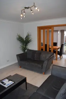 a living room with a couch and a table at 3 Bedroom-Kelpies Serviced Apartments Bruce in Falkirk