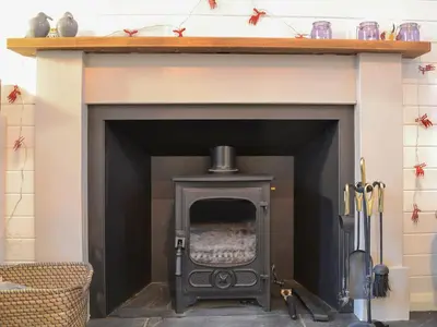 a fireplace with a black stove in a room at Craig Lora in Dalmally