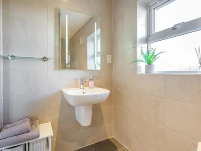 a bathroom with a sink and a mirror at Woodend Barn in Auchterarder