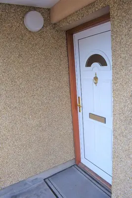a white door with a gold knocker on a building at Kelpies Serviced Apartments Alexander- 2 Bedrooms in Falkirk