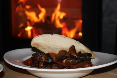 a plate of food with a sandwich with mushrooms on it at The Carradale Hotel in Carradale