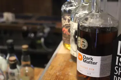 a bottle of dark matter sitting on a wooden table at The Carradale Hotel in Carradale