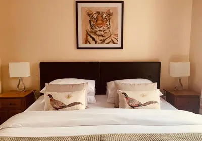 a bedroom with a bed with a picture of a tiger at The Webstersland Residence in Edinburgh