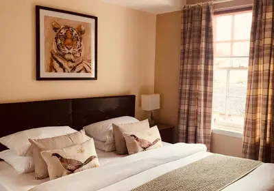a bedroom with a bed with a picture of a tiger at The Webstersland Residence in Edinburgh