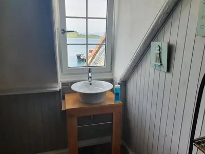 a sink in a room with a window at Argyll Mansions Penthouse in Oban