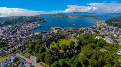 an aerial view of a city and a lake at Argyll Mansions Penthouse in Oban