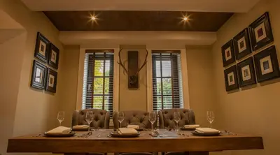 a dining room with a wooden table and chairs at Crowwood Hotel and Alba Restaurant in Chryston