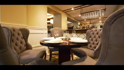 a dining room with a table and chairs at Crowwood Hotel and Alba Restaurant in Chryston