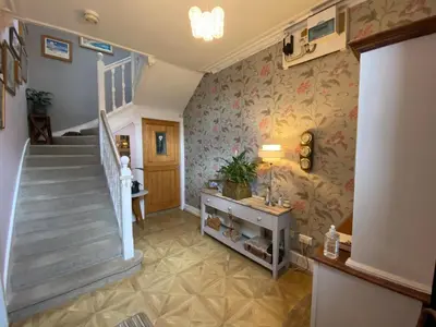 a hallway with a staircase and a stair case at Alpine cottage in Crieff