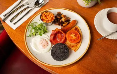 a plate of breakfast food on a table at Fairfield House Hotel in Ayr