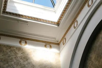a coffered ceiling with gold detailing and a skylight at Nira Caledonia in Edinburgh