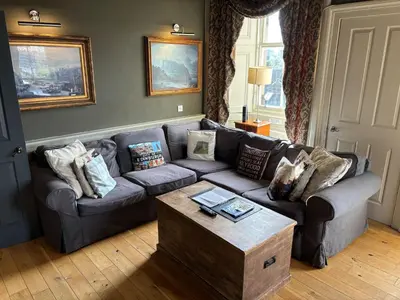 a living room with a couch and a coffee table at The Castle Esplanade Residence in Edinburgh