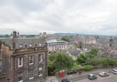 a view of a city with cars and buildings at The Castle Esplanade Residence in Edinburgh