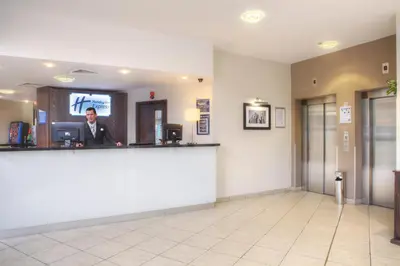 a man sitting at a bar in a waiting room at Holiday Inn Express - Glasgow - City Ctr Theatreland by IHG in Glasgow