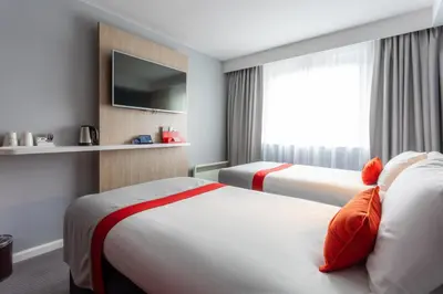 a hotel room with two beds and a tv at Holiday Inn Express - Glasgow - City Ctr Theatreland by IHG in Glasgow