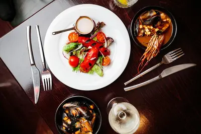 a wooden table with a plate of food on it at Angels Share Hotel in Edinburgh
