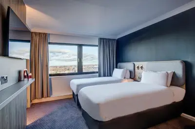 a hotel room with two beds and a window at Holiday Inn Express Edinburgh City West by IHG in Edinburgh