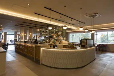 a bar in a restaurant with a counter top at Holiday Inn Edinburgh Zoo by IHG in Edinburgh