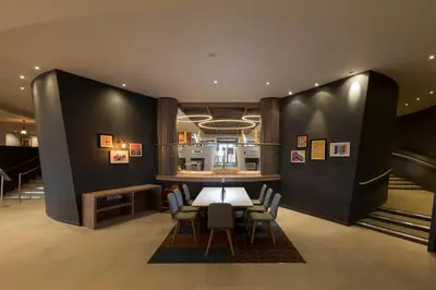 a dining room with a table and chairs at Holiday Inn Edinburgh Zoo by IHG in Edinburgh