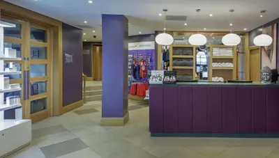 a store with a purple counter and pendant lights at Glasgow Westerwood Hotel, Spa & Golf Resort in Cumbernauld
