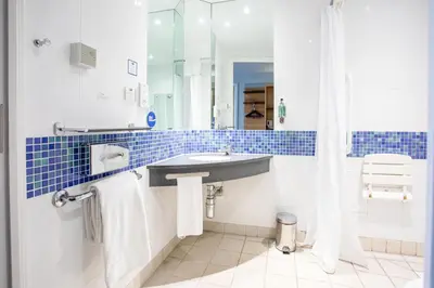 a bathroom with a sink and a mirror at Holiday Inn Express Dunfermline by IHG in Dunfermline