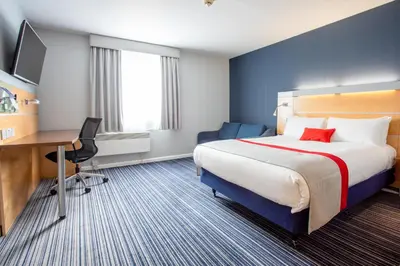 a hotel room with a bed and a desk at Holiday Inn Express Dunfermline by IHG in Dunfermline