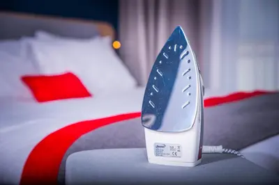 a blue and white iron sitting on top of a bed at Holiday Inn Express Dunfermline by IHG in Dunfermline