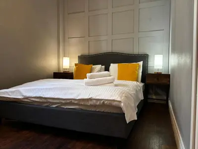 a bedroom with a large bed with yellow pillows at Safestay Glasgow Charing Cross in Glasgow