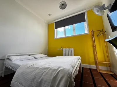 a bedroom with two beds and a window at Safestay Glasgow Charing Cross in Glasgow