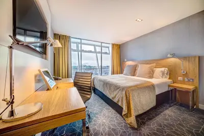 a hotel room with a bed and a desk at Apex City of Glasgow Hotel in Glasgow