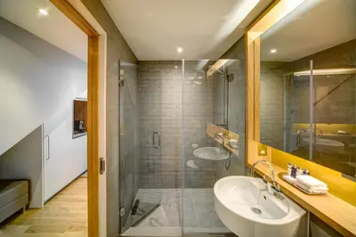 a bathroom with a sink and a shower at Apex City of Glasgow Hotel in Glasgow