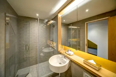 a bathroom with a sink and a glass shower at Apex City of Glasgow Hotel in Glasgow
