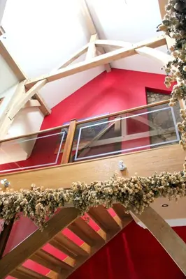 a balcony of a red building with plants on it at Backbrae House B&B in Lanark