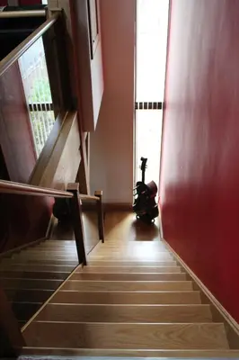 a stairway with a wheelchair in a room with a window at Backbrae House B&B in Lanark