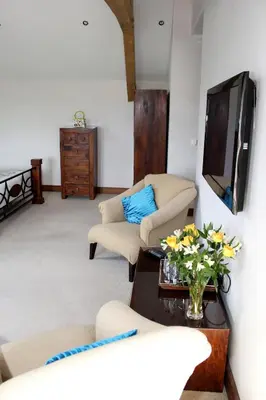 a living room with two couches and a tv at Backbrae House B&B in Lanark