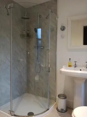 a shower stall in a bathroom with a sink at Lubnaig Guest House in Callander