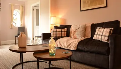 a living room with a couch and a table at Creag Mhor Lodge in Onich