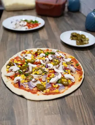 a pizza sitting on top of a wooden table at The County Hotel in Helensburgh